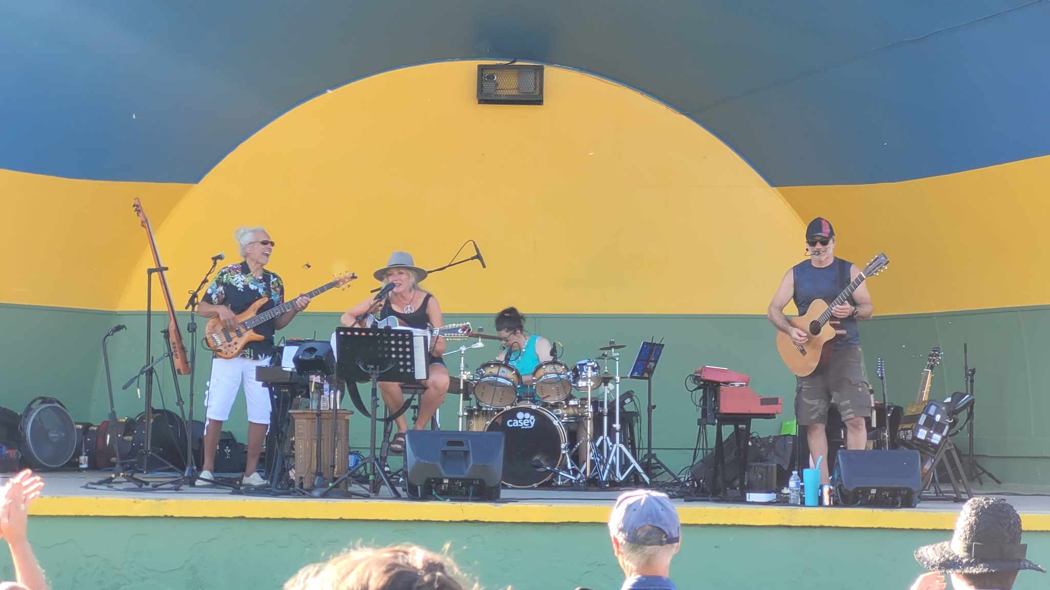 Damn Chandelier performing live under an outdoor bandshell during a daytime community music festival